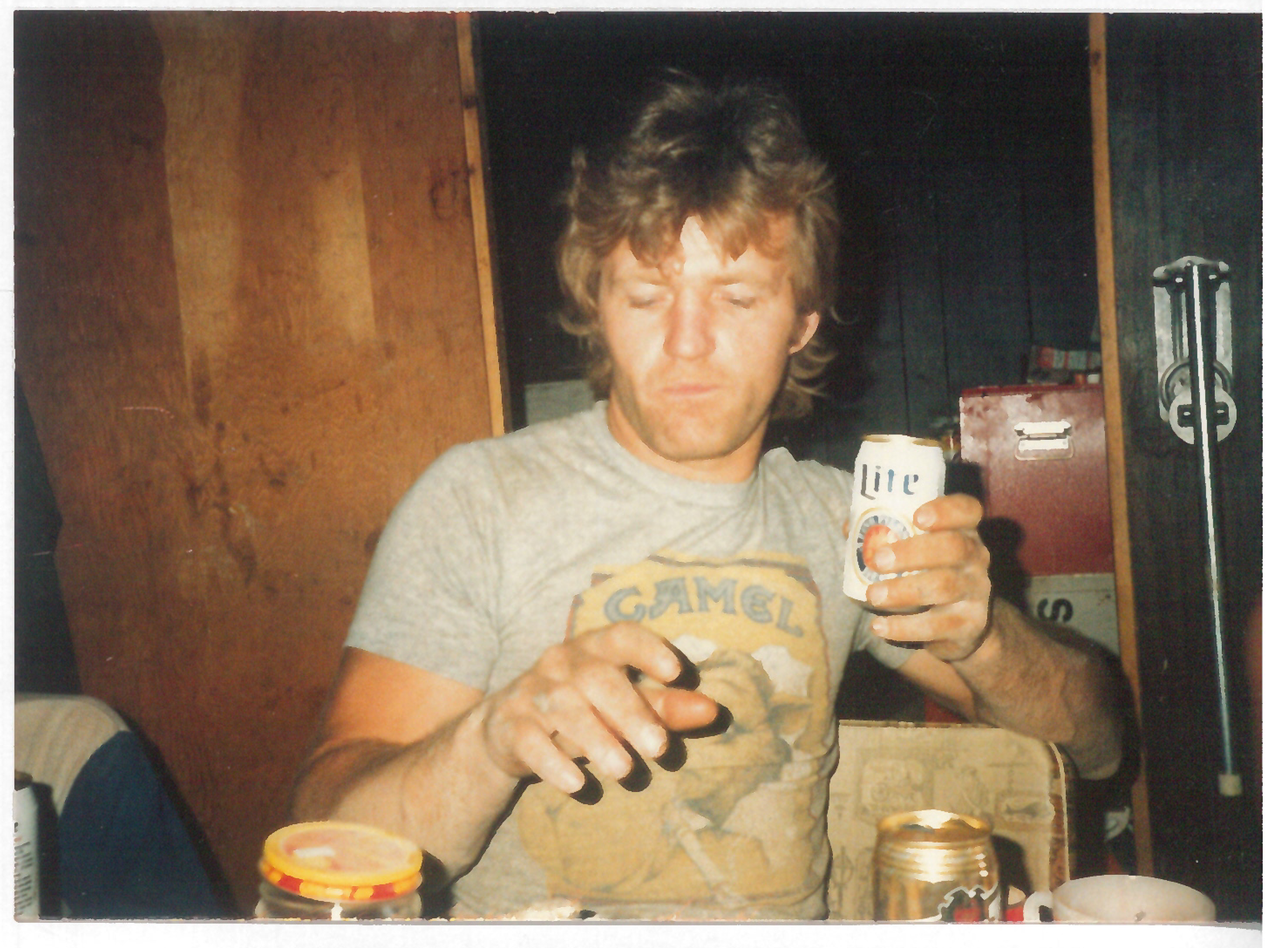 Tim in the old splitter shed break room having a beer with the other employees after a day of splitting stone. 